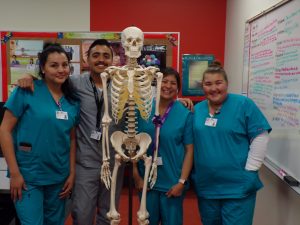 CNA students with skeleton